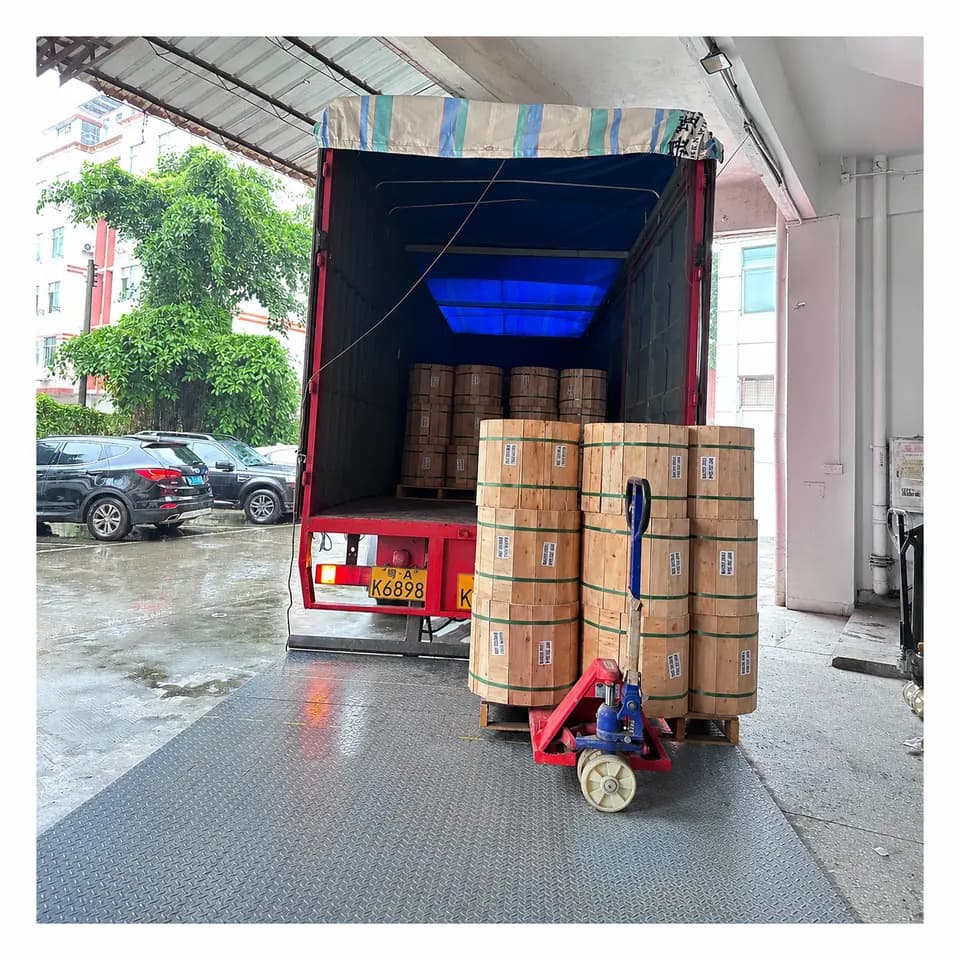 Wooden cable drums being loaded for export shipment